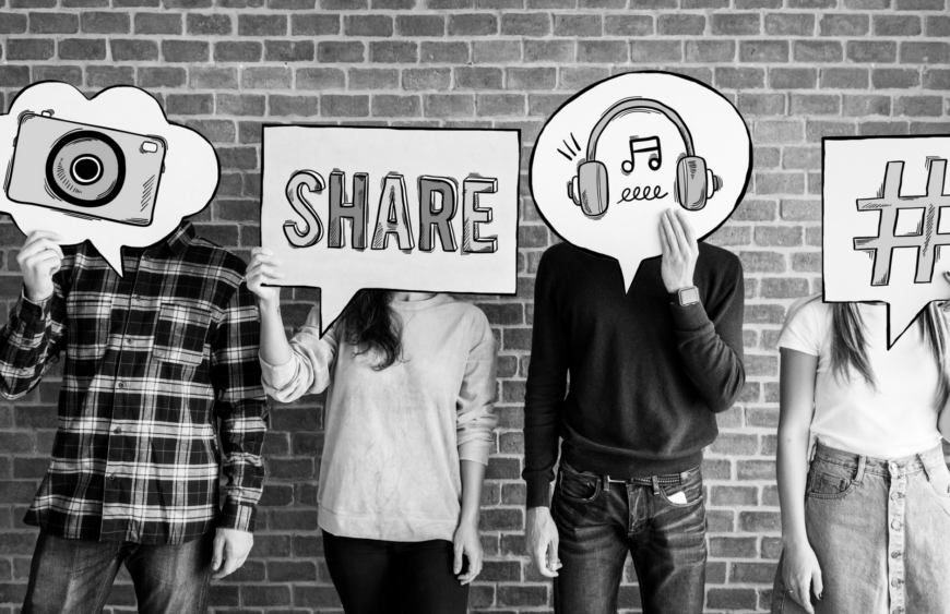 A picture of people holding up social media symbols